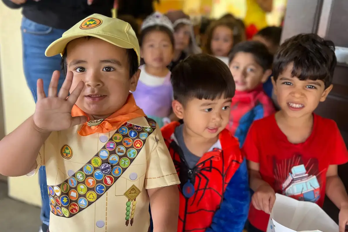 Children smiling at the camera at Newport Ave Preschool's Spanish-English dual language immersion program